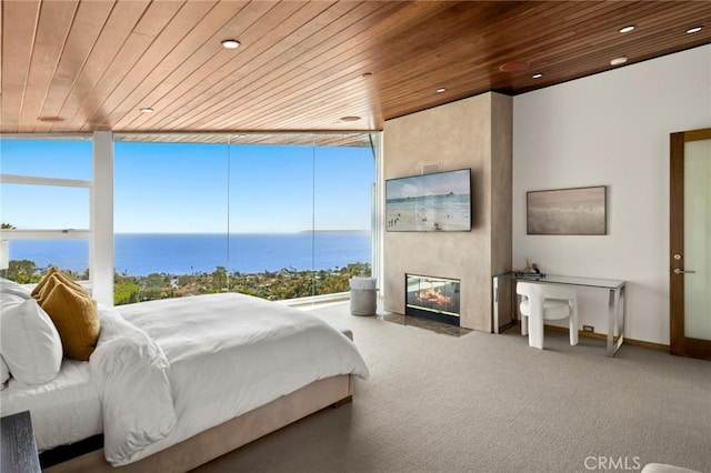 856 Diamond, Laguna Beach, CA 92651 - bedroom with wooden ceiling, a wall of windows, carpet, a fireplace with flush hearth, and recessed lighting