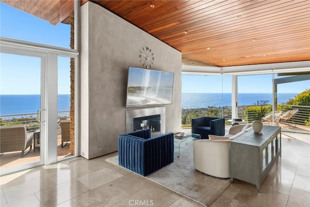 856 Diamond, Laguna Beach, CA 92651 - living area with wood ceiling, a wall of windows, a water view, tile patterned flooring, and a multi sided fireplace