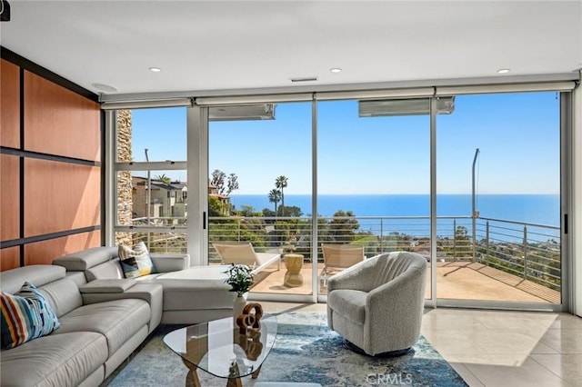 856 Diamond, Laguna Beach, CA 92651 - living area with a wall of windows, tile patterned floors, healthy amount of natural light, and a water view