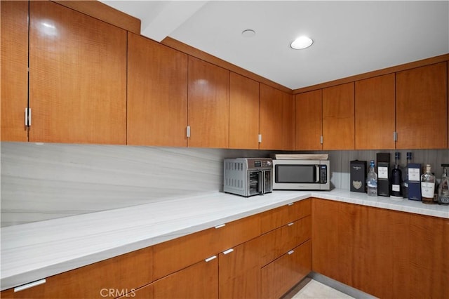 856 Diamond, Laguna Beach, CA 92651 - kitchen featuring stainless steel microwave, light countertops, and brown cabinetry