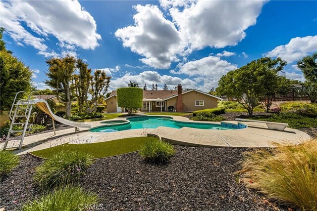 9492 Brynmar Dr, Villa Park, CA 92861 - view of swimming pool with a water slide, a patio, and a pool with connected hot tub