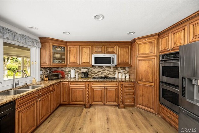 9492 Brynmar Dr, Villa Park, CA 92861 - kitchen featuring stainless steel appliances, a sink, brown cabinets, and recessed lighting