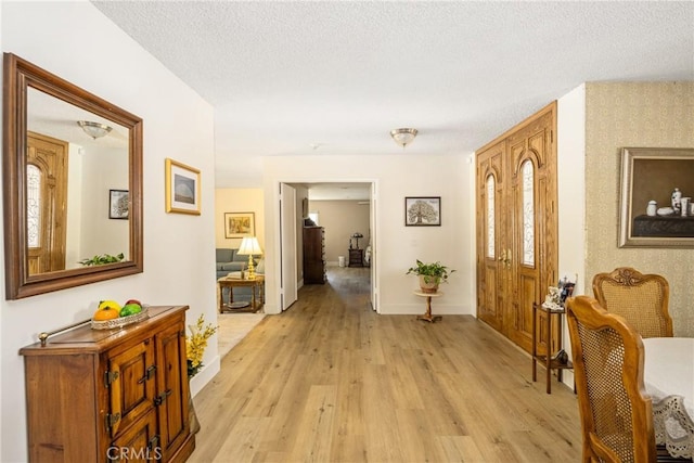 9492 Brynmar Dr, Villa Park, CA 92861 - foyer entrance featuring light wood finished floors, baseboards, wallpapered walls, and a textured ceiling