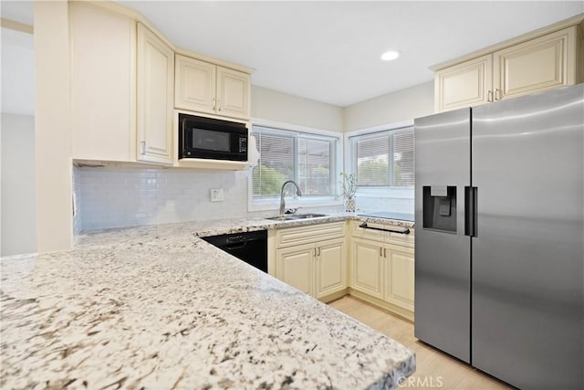 23821 Norma Dr, Menifee, CA 92587 - kitchen featuring black appliances, cream cabinets, a sink, decorative backsplash, and light stone counters