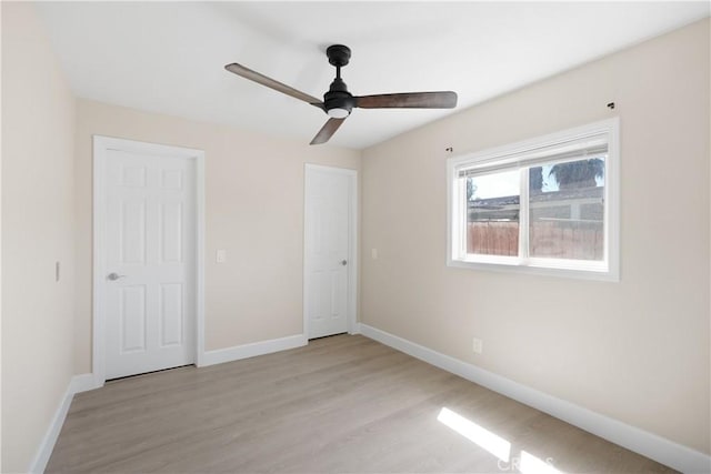 23821 Norma Dr, Menifee, CA 92587 - unfurnished bedroom with baseboards, light wood-style floors, and a ceiling fan