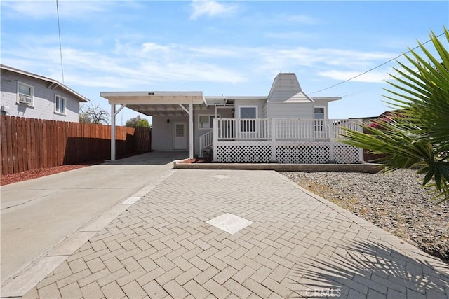 23821 Norma Dr, Menifee, CA 92587 - view of front of home with concrete driveway, fence, a carport, and cooling unit