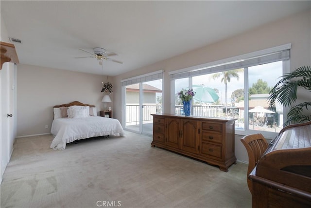 bedroom with light colored carpet, access to outside, visible vents, and multiple windows