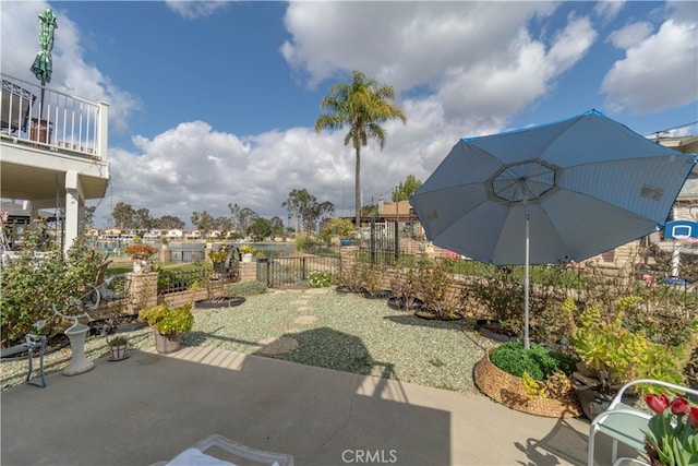 view of patio / terrace featuring fence and a balcony