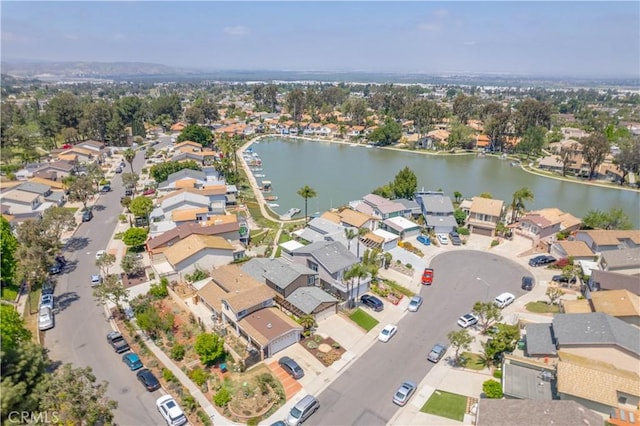 drone / aerial view with a water view and a residential view