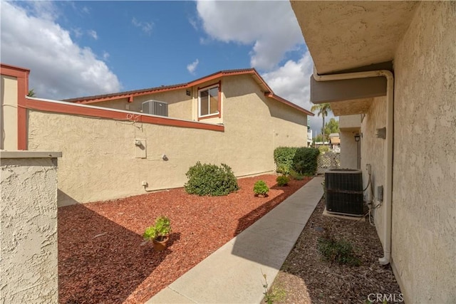 view of property exterior featuring cooling unit and stucco siding