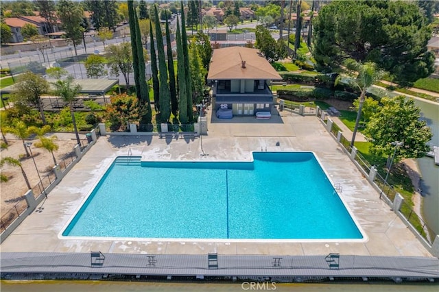 pool with fence and a patio