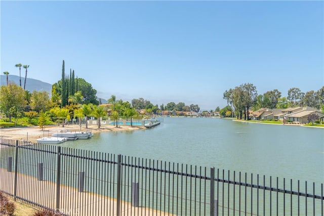 property view of water with a mountain view and fence
