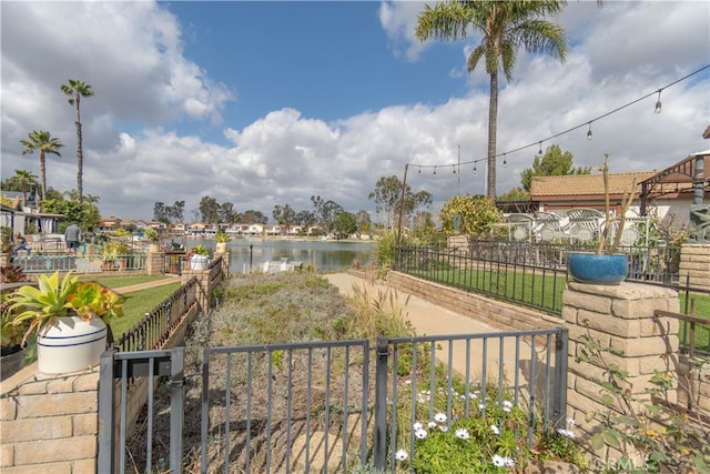 view of community featuring a water view and fence private yard