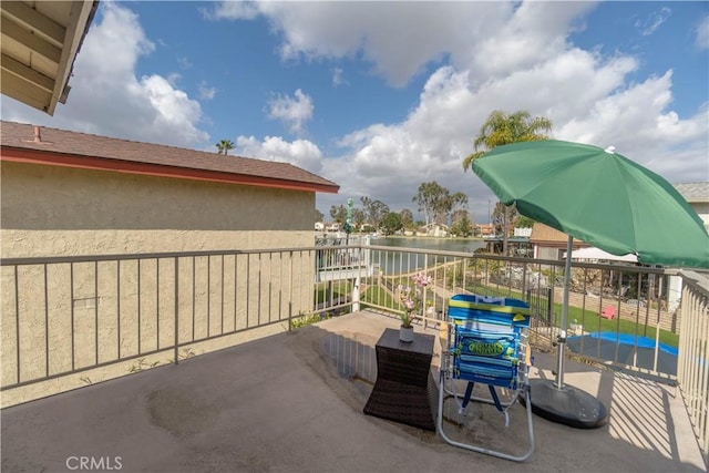 view of patio / terrace featuring a water view and a balcony