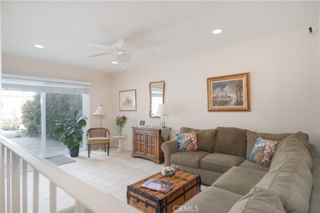 living area featuring light colored carpet, baseboards, a ceiling fan, and recessed lighting
