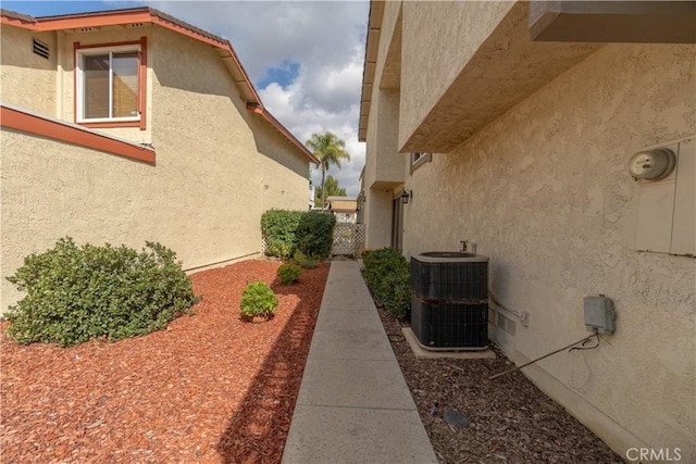 view of property exterior featuring central air condition unit and stucco siding