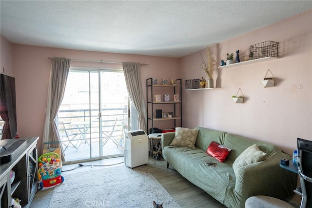 327 Chestnut Ave Unit 201, Long Beach, CA 90802 - living area featuring wood finished floors and a textured ceiling