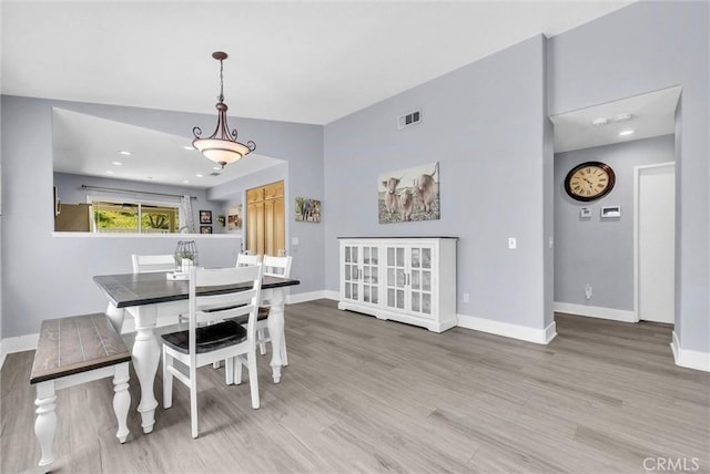 dining space featuring visible vents, wood finished floors, and baseboards