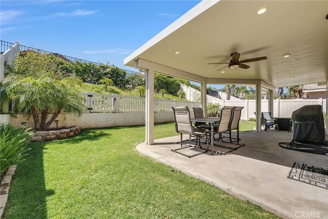 view of yard featuring a fenced backyard, a patio, and a ceiling fan