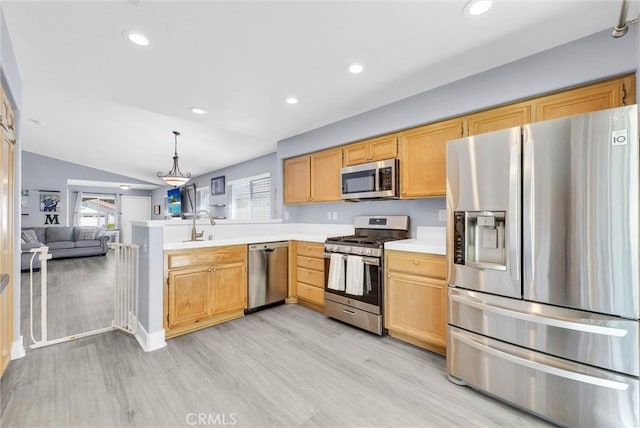 976 Miraflores Dr, Corona, CA 92882 - kitchen featuring stainless steel appliances, light wood finished floors, light countertops, vaulted ceiling, and a peninsula