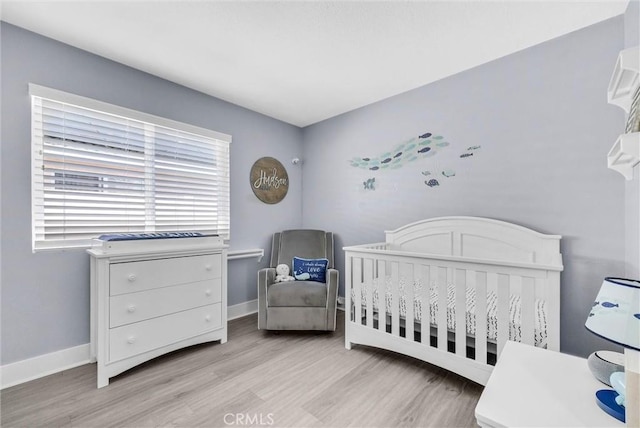976 Miraflores Dr, Corona, CA 92882 - bedroom with light wood-type flooring and a nursery area