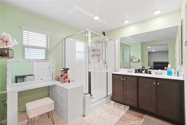 26643 Baneberry Ct, Menifee, CA 92585 - full bathroom featuring a stall shower, vanity, and wood finished floors