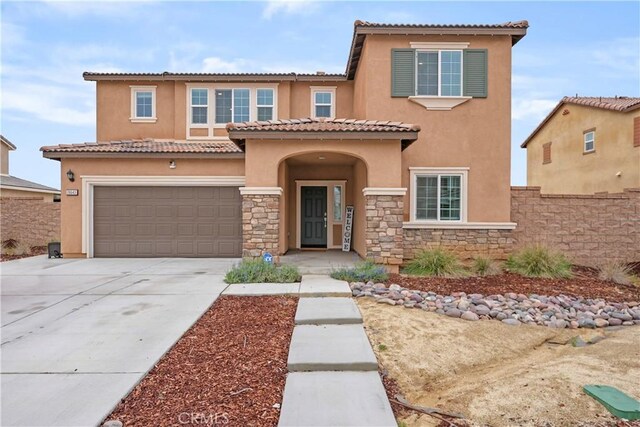 26643 Baneberry Ct, Menifee, CA 92585 - mediterranean / spanish-style home featuring stucco siding, driveway, stone siding, an attached garage, and fence