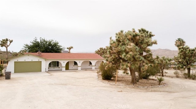 ranch-style house with an attached garage and driveway