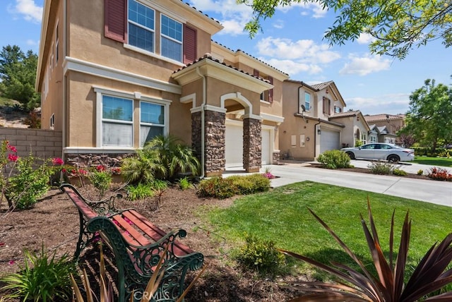 19321 Carranza Ln, Saugus, CA 91350 - mediterranean / spanish house with stone siding, a garage, stucco siding, a front yard, and driveway