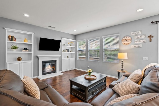 19321 Carranza Ln, Saugus, CA 91350 - living room with visible vents, built in shelves, recessed lighting, dark wood-style flooring, and a glass covered fireplace
