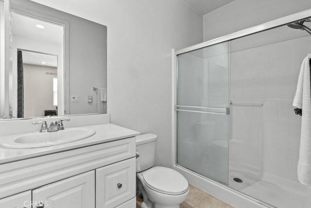 19321 Carranza Ln, Saugus, CA 91350 - bathroom with a shower stall, toilet, vanity, and tile patterned floors