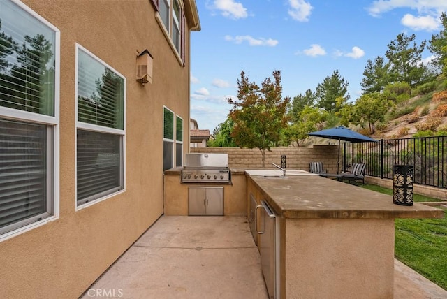 19321 Carranza Ln, Saugus, CA 91350 - view of patio featuring a fenced backyard, an outdoor kitchen, a sink, and grilling area