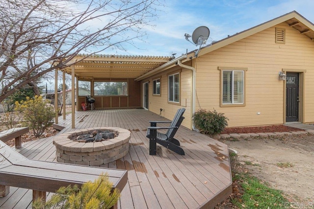 deck featuring a pergola and an outdoor fire pit