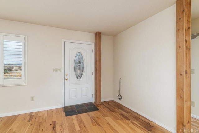 entryway featuring baseboards and light wood-style flooring