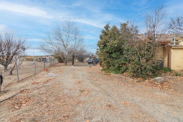 view of road featuring driveway and a gate