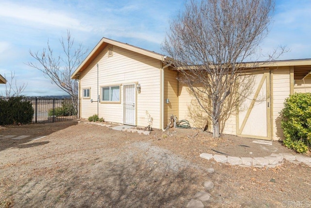 view of outbuilding with fence