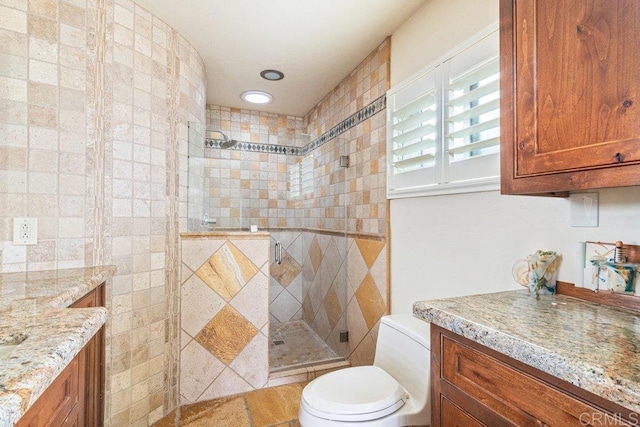bathroom featuring toilet and a stall shower