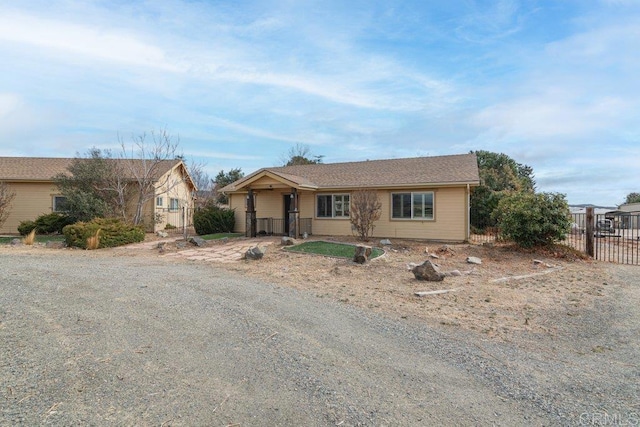 ranch-style house with fence