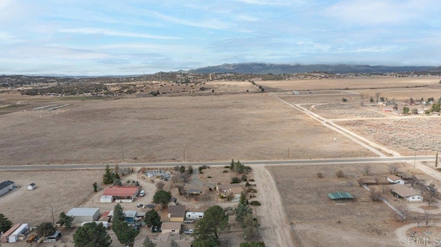 drone / aerial view featuring a rural view and a desert view