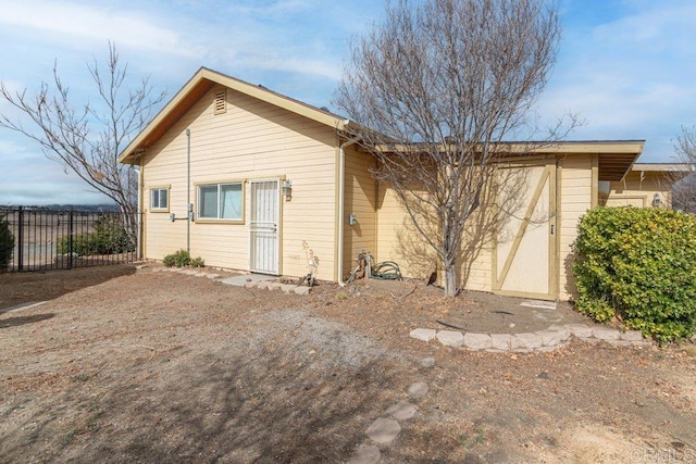 back of house featuring fence
