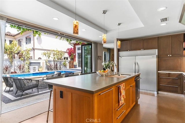 291 Argonne Ave, Long Beach, CA 90803 - kitchen featuring stainless steel appliances, an island with sink, recessed lighting, decorative light fixtures, and concrete floors