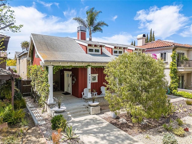 291 Argonne Ave, Long Beach, CA 90803 - view of front of home featuring a chimney, a porch, board and batten siding, and a shingled roof
