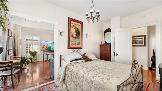140 Linden Ave Unit 962, Long Beach, CA 90802 - bedroom featuring a chandelier and wood finished floors
