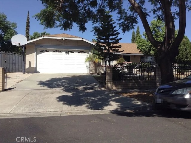ranch-style house featuring an attached garage, stucco siding, driveway, and fence