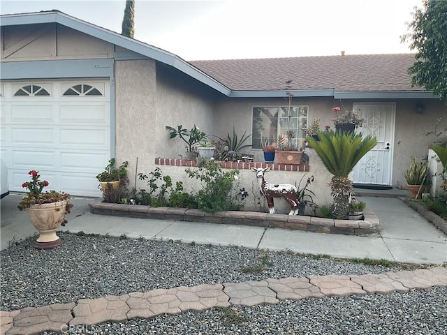 322 N Fillmore Ave, Rialto, CA 92376 - view of front facade featuring stucco siding, roof with shingles, and a garage