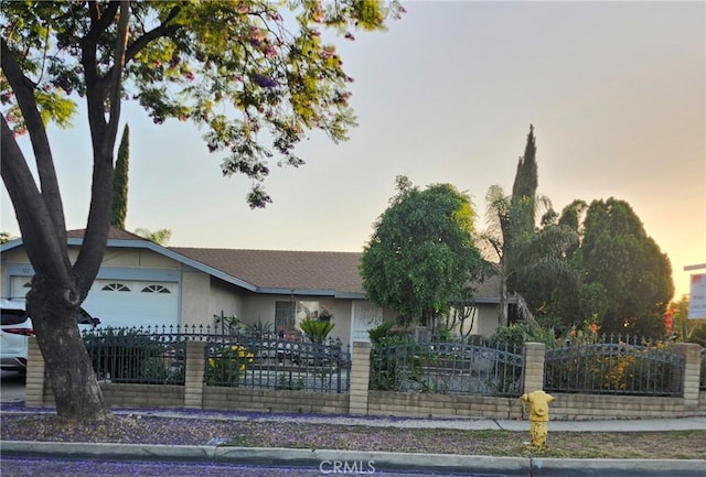 322 N Fillmore Ave, Rialto, CA 92376 - view of front of house featuring a fenced front yard and a garage