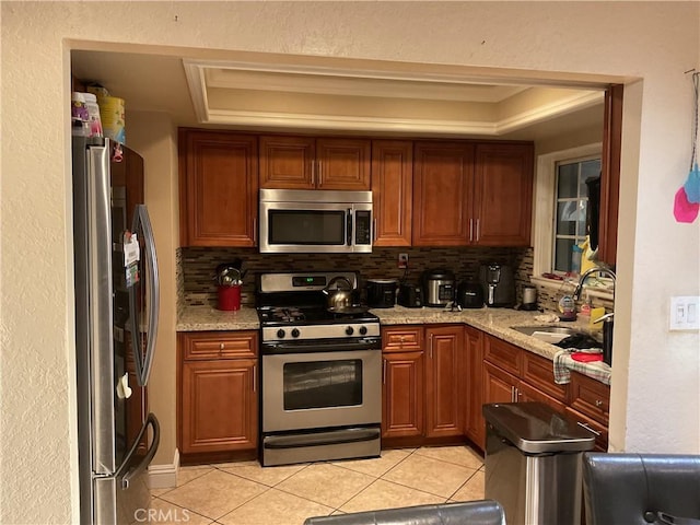 322 N Fillmore Ave, Rialto, CA 92376 - kitchen with stainless steel appliances, light tile patterned floors, decorative backsplash, and a tray ceiling