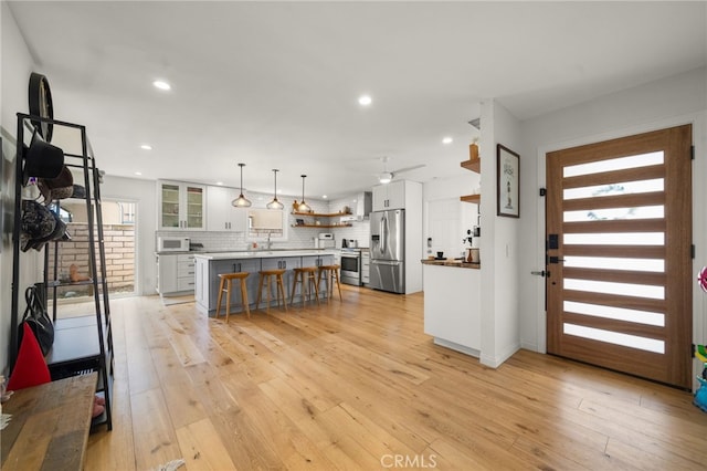 19542 Constellation Ln, Huntington Beach, CA 92646 - kitchen featuring white cabinetry, a wealth of natural light, stainless steel appliances, and open shelves