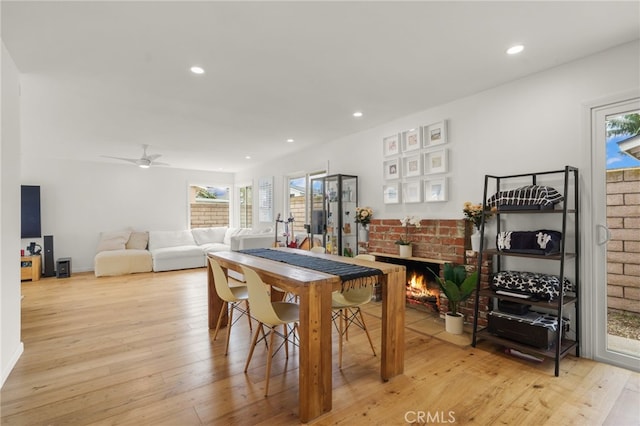 19542 Constellation Ln, Huntington Beach, CA 92646 - dining room with recessed lighting, a wealth of natural light, a fireplace, and light wood-type flooring