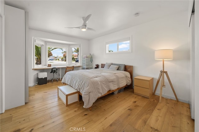 19542 Constellation Ln, Huntington Beach, CA 92646 - bedroom with light wood-style flooring, a ceiling fan, and multiple windows